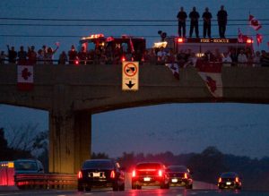 People line a bridge in Whitby, Ontario, Canada to pay respects to the passing convoy for the three deceased soldiers following their repatriation to Canada on Saturday, Aug. 23, 2008. A roadside blast Wednesday killed the three soldiers in the southern Afghanistan province of Kandahar, Canada's Department of National Defense said. Their deaths bring to 93 the number of Canadian soldiers who have died during the Afghan mission since it began in 2002. (AP Photo/The Canadian Press, Frank Gunn)