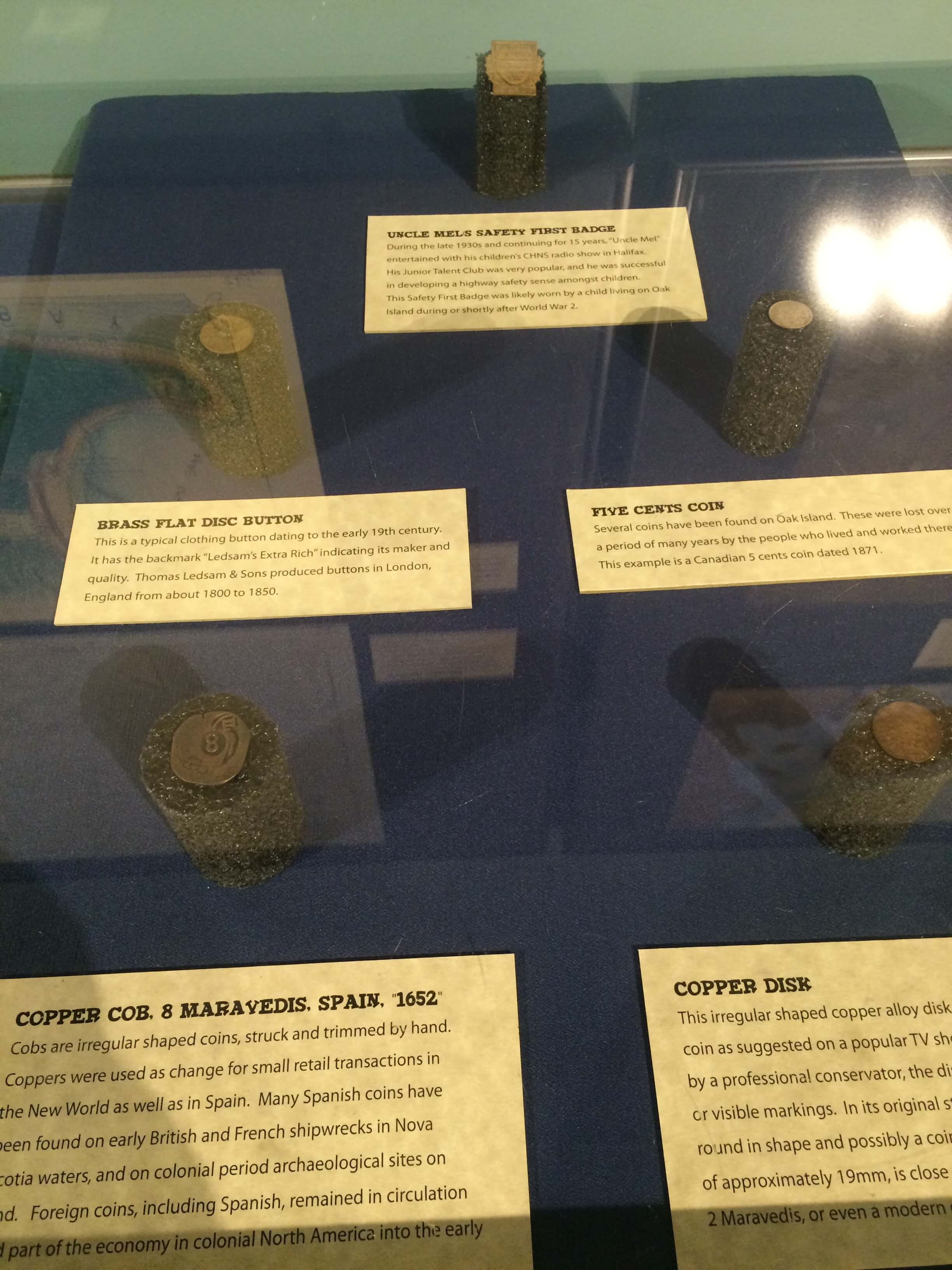 Coins, including a Spanish 8 maravedis, on display at Halifax's Museum of Natural History. Image courtesy of Ryan Phillips.
